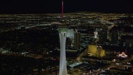 4K aerial stock footage of orbiting top of Stratosphere with city sprawl in background, Las Vegas, Nevada Night Aerial Stock Footage | DCA03_006