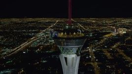 4K aerial stock footage of orbiting top of Stratosphere with city sprawl in background, Las Vegas, Nevada Night Aerial Stock Footage | DCA03_008