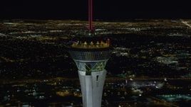 4K aerial stock footage of orbiting top of Stratosphere with city sprawl in background, Las Vegas, Nevada Night Aerial Stock Footage | DCA03_009