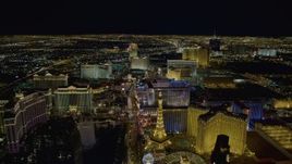 4K aerial stock footage of Las Vegas Boulevard past Planet Hollywood to Flamingo and Caesar's Palace, Las Vegas, Nevada Night Aerial Stock Footage | DCA03_018