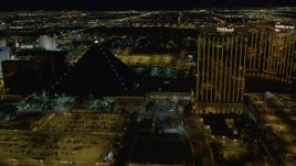 4K aerial stock footage of flying by Luxor Hotel, The Hotel, Mandalay Bay Resort, Las Vegas, Nevada Night Aerial Stock Footage | DCA03_051