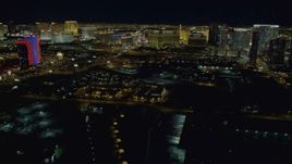 4K aerial stock footage of panning across the Las Vegas Strip revealing hotels, Nevada Night Aerial Stock Footage | DCA03_156