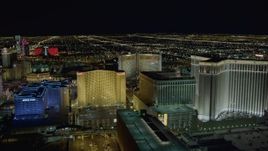 4K aerial stock footage of flying behind Imperial Palace and Harrah's, Las Vegas, Nevada Night Aerial Stock Footage | DCA03_170