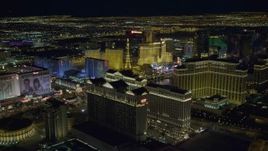 4K aerial stock footage tilt from Caesar's Palace and flyby hotels on Las Vegas Strip, Nevada Night Aerial Stock Footage | DCA03_188