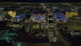 4K aerial stock footage of panning across Las Vegas Strip, zooming in on Caesar's Palace, Nevada Night Aerial Stock Footage | DCA03_189
