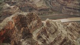 4K aerial stock footage of flying over a rock formation near the Colorado River in Grand Canyon, Arizona Aerial Stock Footage | DCA04_043