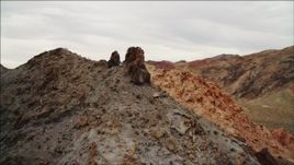 4K aerial stock footage of flying toward a peak in Hiller Mountains, orbiting rock formation, Nevada Aerial Stock Footage | DCA04_078
