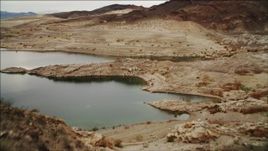 4K aerial stock footage of flying over ridge on shore of Lake Mead, Nevada Aerial Stock Footage | DCA04_086