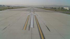 4K aerial stock footage of taxiing onto Van Nuys Airport runway, accelerating, Van Nuys, California Aerial Stock Footage | DCA05_001