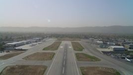 4K aerial stock footage of lifting off from Van Nuys Airport runway, Van Nuys, California Aerial Stock Footage | DCA05_002