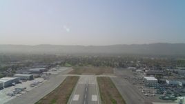 4K aerial stock footage of ascending over runway Van Nuys Airport; Van Nuys, California Aerial Stock Footage | DCA05_003