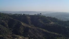 4K aerial stock footage pan across Hollywood Hills, revealing Griffith Observatory, Los Angeles, California Aerial Stock Footage | DCA05_011