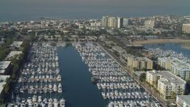 4K aerial stock footage pass boats in the marina, tilt to apartments, Marina Del Rey, California Aerial Stock Footage | DCA05_071