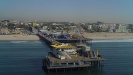 4K aerial stock footage of fly by Santa Monica Pier, ascend and pan back to pier, Santa Monica, California Aerial Stock Footage | DCA05_080