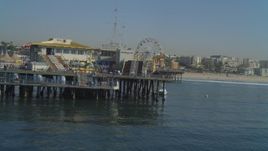 4K aerial stock footage of flying low over ocean, end of the Santa Monica Pier, Santa Monica, California Aerial Stock Footage | DCA05_092