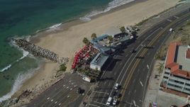 4K aerial stock footage of Highway 1 along the coast, tilt to restaurant, Pacific Palisades, California Aerial Stock Footage | DCA05_099