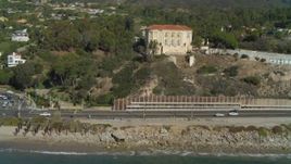 4K aerial stock footage of tilting from the coastline to reveal mansion on a hill Pacific Palisades, California Aerial Stock Footage | DCA05_100