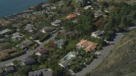4K aerial stock footage pan to reveal neighborhood on cliff overlooking ocean, Malibu, California Aerial Stock Footage | DCA05_108