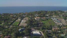 4K aerial stock footage of flying by upscale residential neighborhoods, view of Pacific Ocean, Malibu, California Aerial Stock Footage | DCA05_131