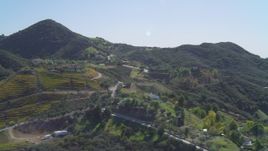 4K aerial stock footage of flying by homes and vineyards in the hills, Malibu, California Aerial Stock Footage | DCA05_136