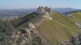 4K aerial stock footage of orbiting winery, vineyards on a hill, Malibu, California Aerial Stock Footage | DCA05_138