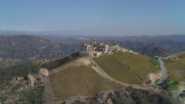 4K aerial stock footage of orbiting a winery and vineyard on a hill, Malibu, California Aerial Stock Footage | DCA05_139