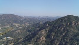4K aerial stock footage of flying by the Santa Monica Mountains, Malibu, California Aerial Stock Footage | DCA05_140