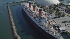 4K aerial stock footage approach RMS Queen Mary, tilt for bird's eye of ship, Long Beach, California Aerial Stock Footage | DCA06_024