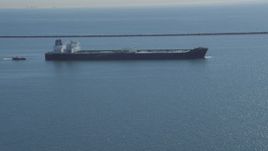 4K aerial stock footage of flying away from oil tanker near breakwater, Long Beach, California Aerial Stock Footage | DCA06_026