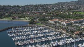 4K aerial stock footage of flying by a hotel and a marina full of boats in San Pedro, California Aerial Stock Footage | DCA06_046