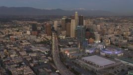 4K aerial stock footage of flying by Highway 110, tilt up to reveal Downtown skyscrapers, Los Angeles, California, twilight Aerial Stock Footage | DCA07_015