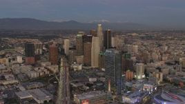 4K aerial stock footage of approaching Downtown skyscrapers, The Ritz-Carlton, mountains in the distance, Los Angeles, California, twilight Aerial Stock Footage | DCA07_016