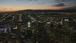 4K aerial stock footage of flying by Downtown skyscrapers, view of Los Angeles Basin, Santa Monica Mountains, California, twilight Aerial Stock Footage | DCA07_051