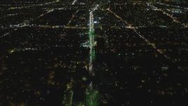 4K aerial stock footage of following Wilshire Blvd, reveal Century City, Mid-Wilshire, Los Angeles, California, night Aerial Stock Footage | DCA07_073