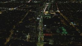 4K aerial stock footage of following Wilshire Blvd through Mid-Wilshire, Los Angeles, California, night Aerial Stock Footage | DCA07_076
