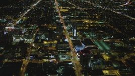 4K aerial stock footage of following Sunset Boulevard, tilt down on Cinerama Dome, Hollywood, California, night Aerial Stock Footage | DCA07_083