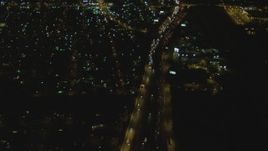 4K aerial stock footage of flying away from Interstate 710, reveal interchange with Highway 91, Long Beach, California, night Aerial Stock Footage | DCA07_120