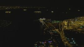 4K aerial stock footage of RMS Queen Mary, Carnival Cruise Lines building, Port of Long Beach, California, night Aerial Stock Footage | DCA07_125
