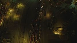 4K aerial stock footage of flying over trucks lined up at Port of Long Beach, California, night Aerial Stock Footage | DCA07_128
