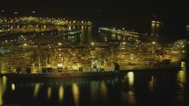 4K aerial stock footage of approaching cargo ship and cranes at Port of Long Beach, California, night Aerial Stock Footage | DCA07_136
