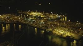 4K aerial stock footage of approaching cargo containers, cranes at the Port of Long Beach, California, night Aerial Stock Footage | DCA07_139