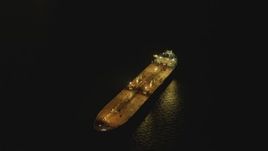 4K aerial stock footage of flying by oil tanker sailing near Port of Long Beach, tilt to black, California, night Aerial Stock Footage | DCA07_149