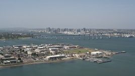 4K aerial stock footage of a reverse view of the Coronado Bridge, city skyline, and military base, San Diego, California Aerial Stock Footage | DCA08_025