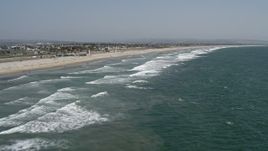 4K aerial stock footage of flying over ocean waves near a beach, Coronado, California Aerial Stock Footage | DCA08_027