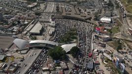 4K aerial stock footage orbit and fly over heavy border traffic to reveal the freeway at the US/Mexico Border, Tijuana Aerial Stock Footage | DCA08_054E