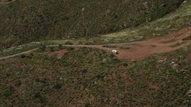 4K aerial stock footage orbit Border Patrol truck on a green hill, US/Mexico Border, Tijuana Aerial Stock Footage | DCA08_075N