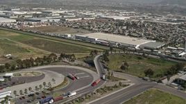 4K aerial stock footage orbit trucks and warehouses on the US/Mexico Border, Tijuana, Mexico Aerial Stock Footage | DCA08_094