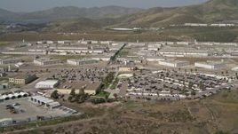 4K aerial stock footage tilt from hill to reveal prison, Otay Mesa, California Aerial Stock Footage | DCA08_102E