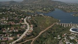 4K aerial stock footage flyby water treatment plant, dam and lake to reveal upscale homes, Del Cerro, California Aerial Stock Footage | DCA08_134