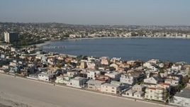 4K aerial stock footage of passing by beachfront condos and a bay, Mission Beach, California Aerial Stock Footage | DCA08_234